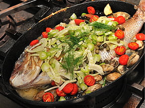 鯛に野菜を盛りつける写真。